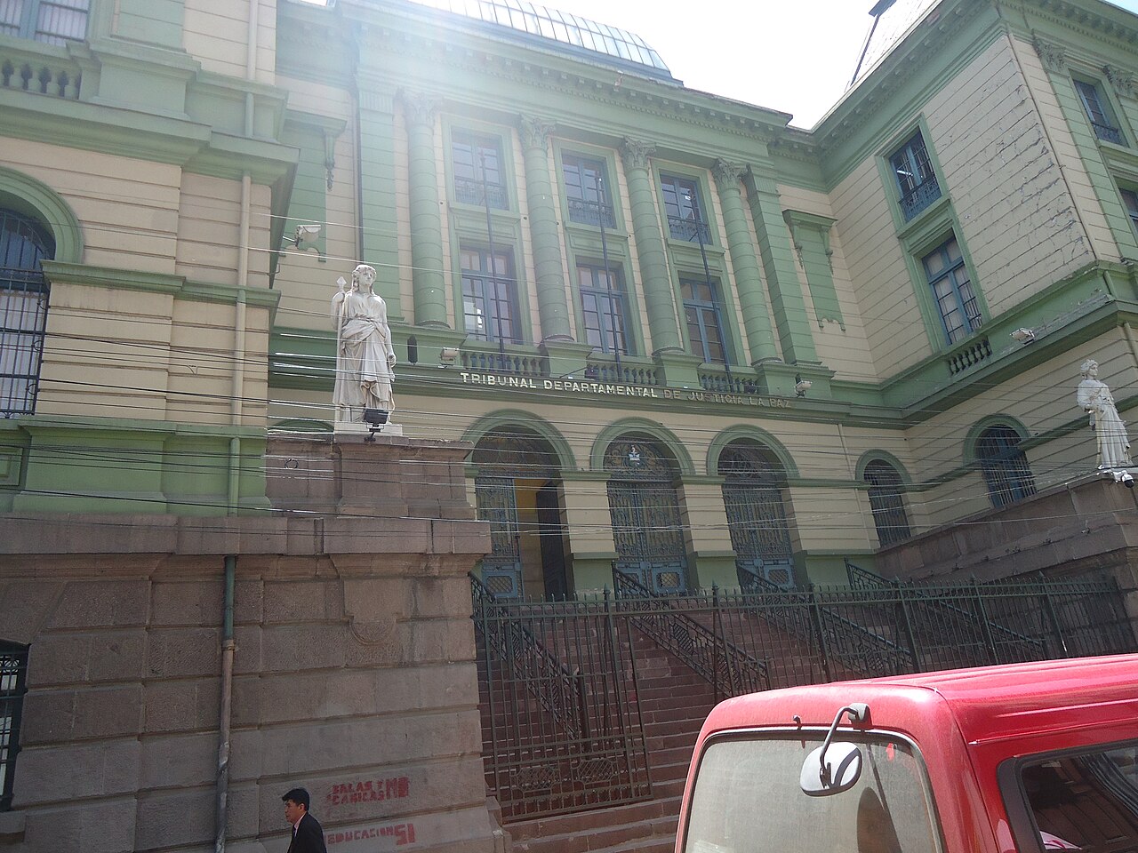 Fachada del Tribunal Departamental de Justicia de La Paz, con el letrero del edificio y una estatua de la Justicia en primer plano