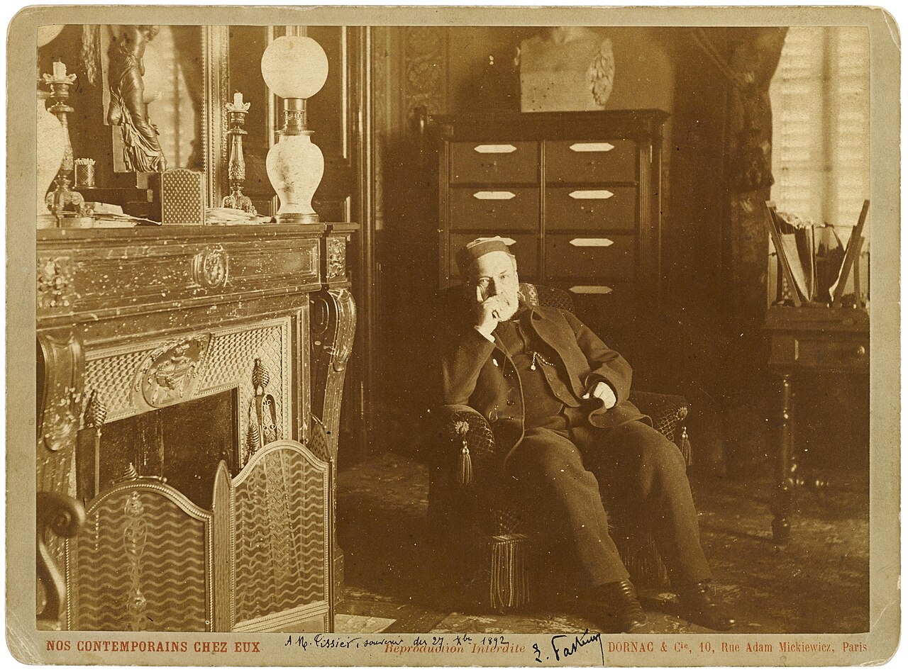 Retrato en sepia de Louis Pasteur sentado en un sillón de su despacho, junto a una chimenea, fotografiado hacia 1892